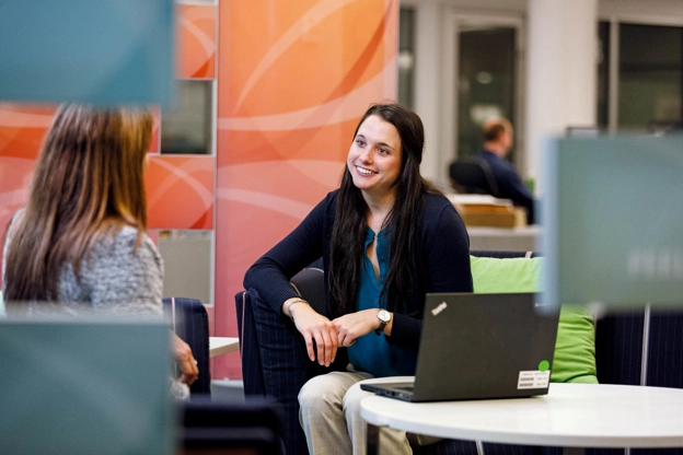 Kelly talking with a colleague