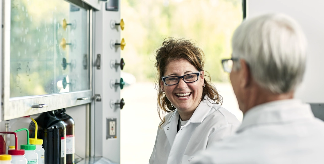 Women in a lab laughing together