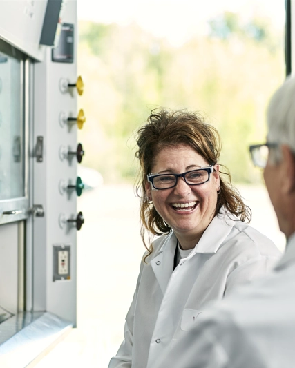 Women in a lab laughing together